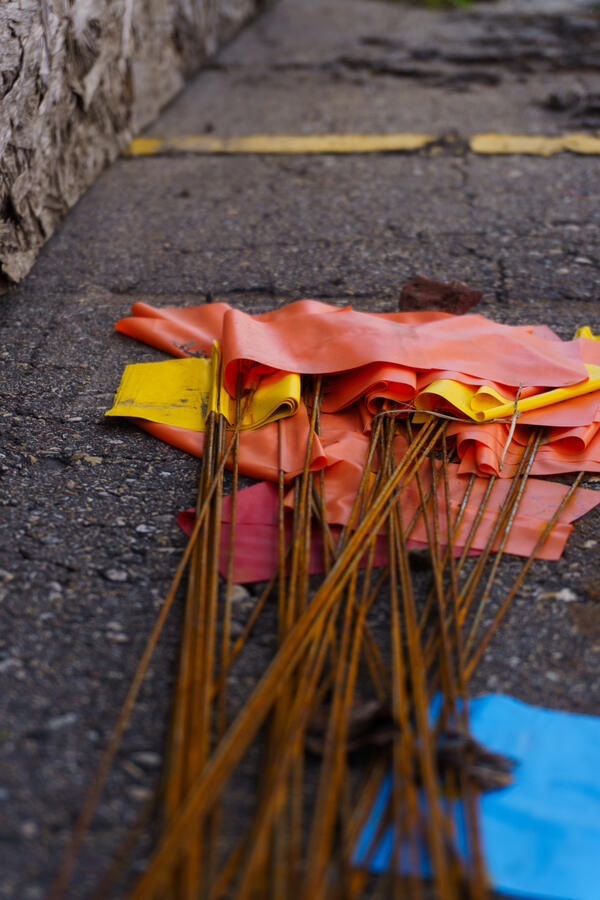 Utility marker flags discarded on the street.
